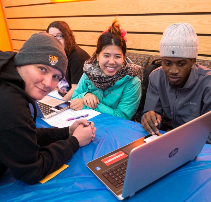 Four students with a laptop