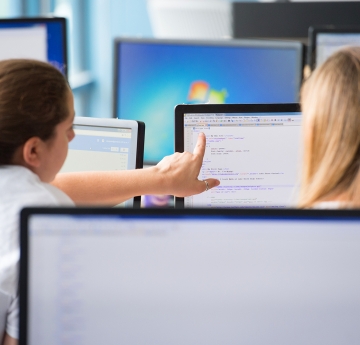 Students pointing to a computer screen