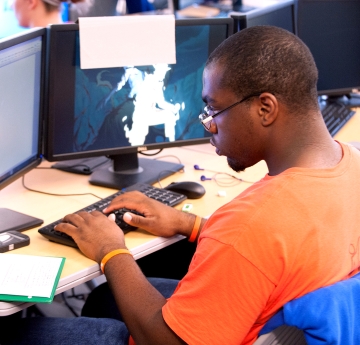 Student working on a monitor in class